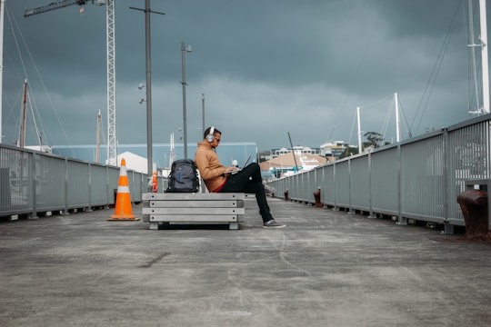 person sitting on bench wearing headphones