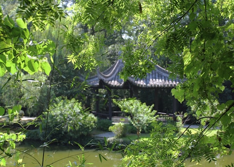 A serene traditional Javanese pavilion surrounded by lush greenery at sunrise