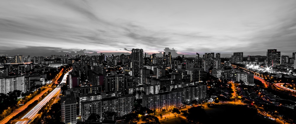 selective color photography of road between buildings