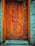 A beautifully crafted custom wooden door installed in a modern home.