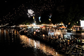 Colorful festive decorations and traditional lamps lighting up the evening along the river.