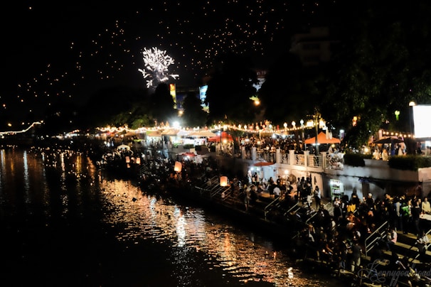 Colorful festive decorations and traditional lamps lighting up the evening along the river.