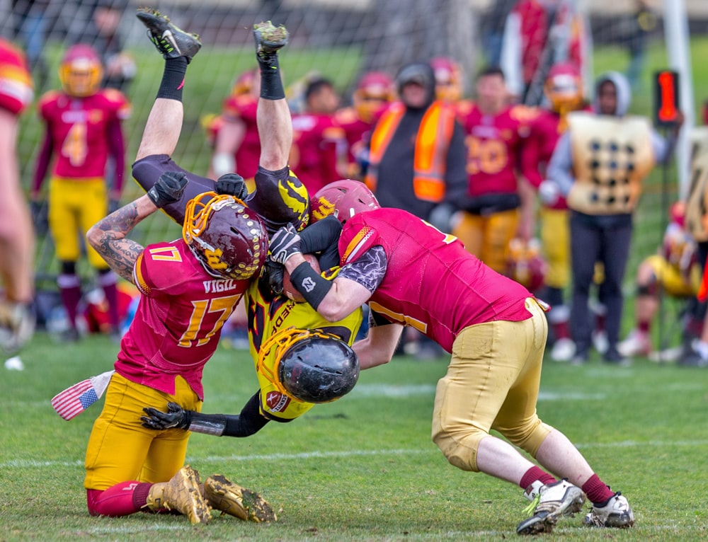 photo of three men playing football