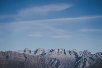 Panoramic view of rugged mountain ridges under a clear blue sky.