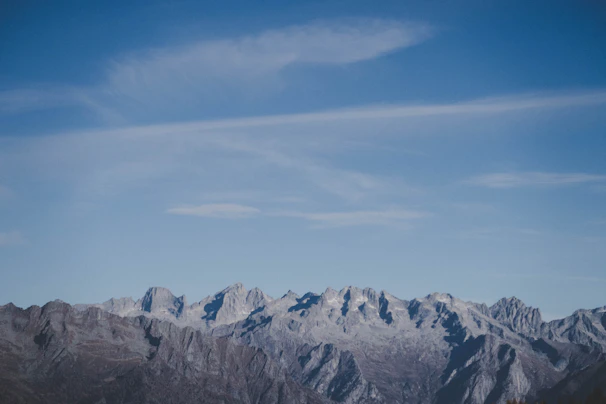Panoramic view of rugged mountain ridges under a clear blue sky.
