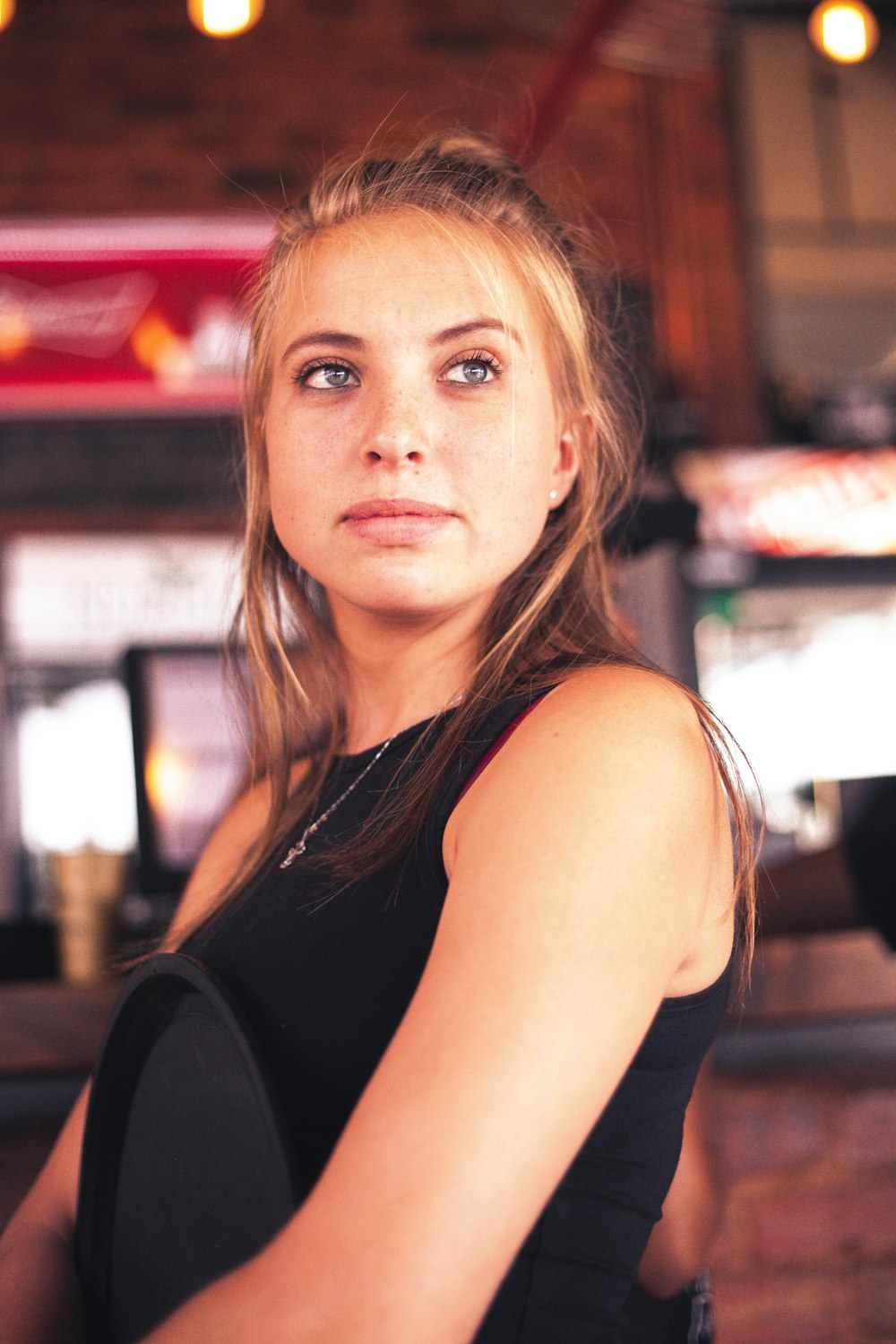 woman holding black wooden panel