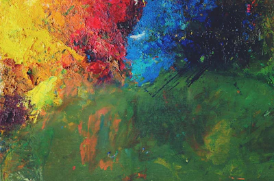 Close-up of a vibrant oil painting in progress with rich textures.