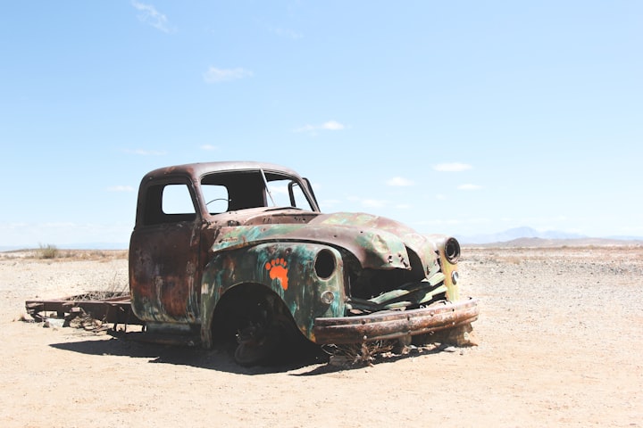 Old, rusted out pickup (that is nonetheless still standing).