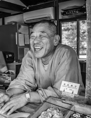 A smiling technician fixing an air conditioner in a cozy home.