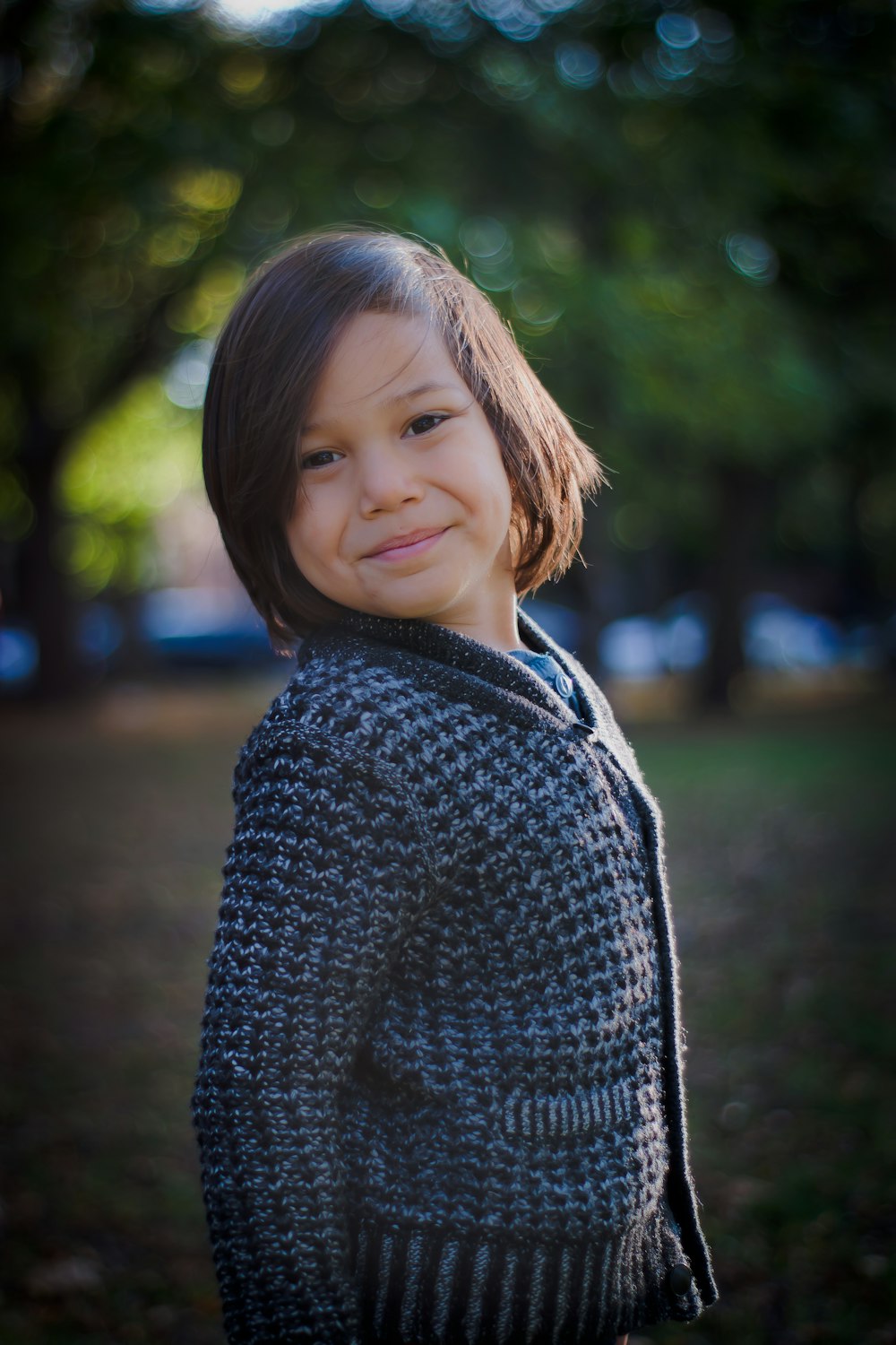 selective focus photo of toddler in black cardigan