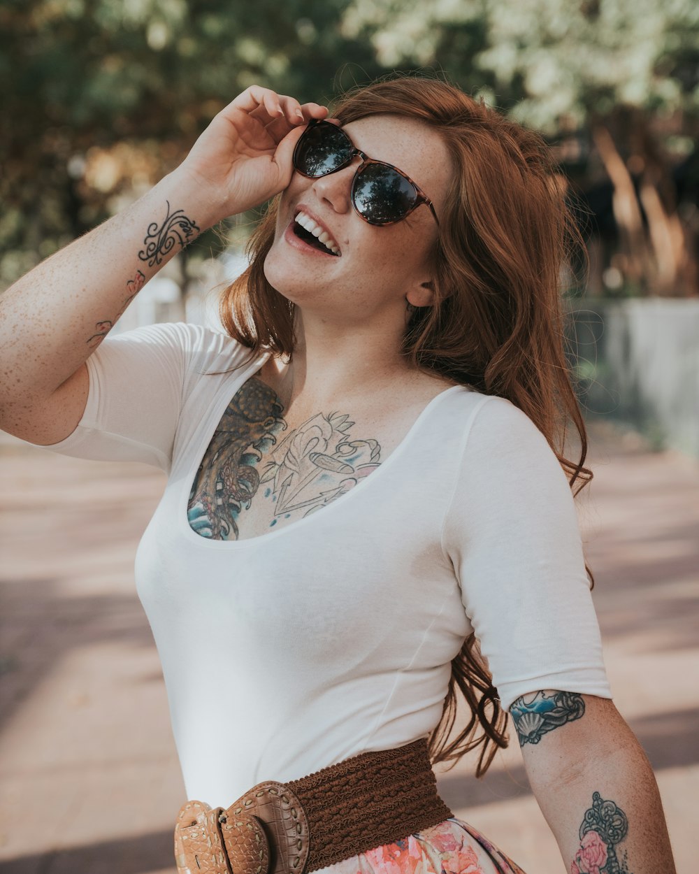 woman touching her sunglasses during daytime