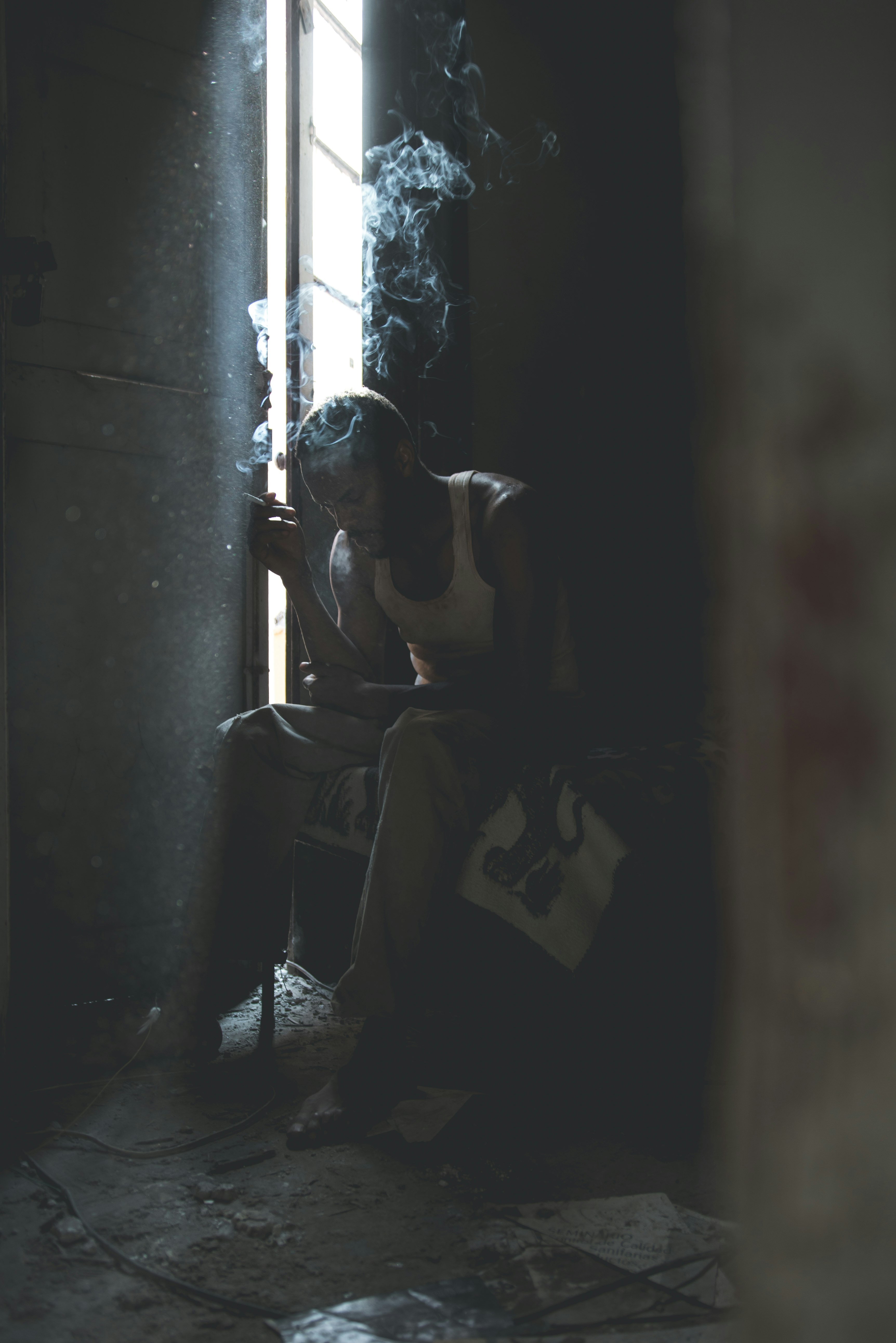 man smoking sitting on chair