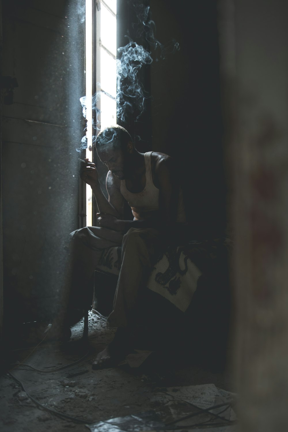 man smoking sitting on chair