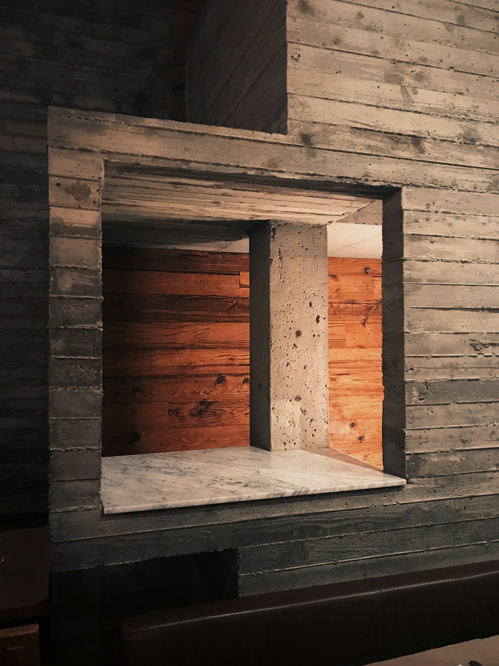 a room with a wooden wall and a window