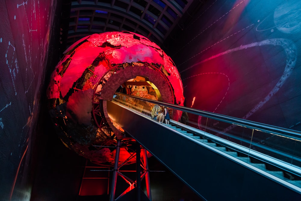 a large red object sitting inside of a tunnel