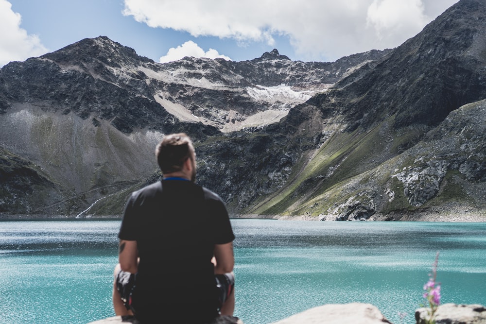 man standing in front of mountain