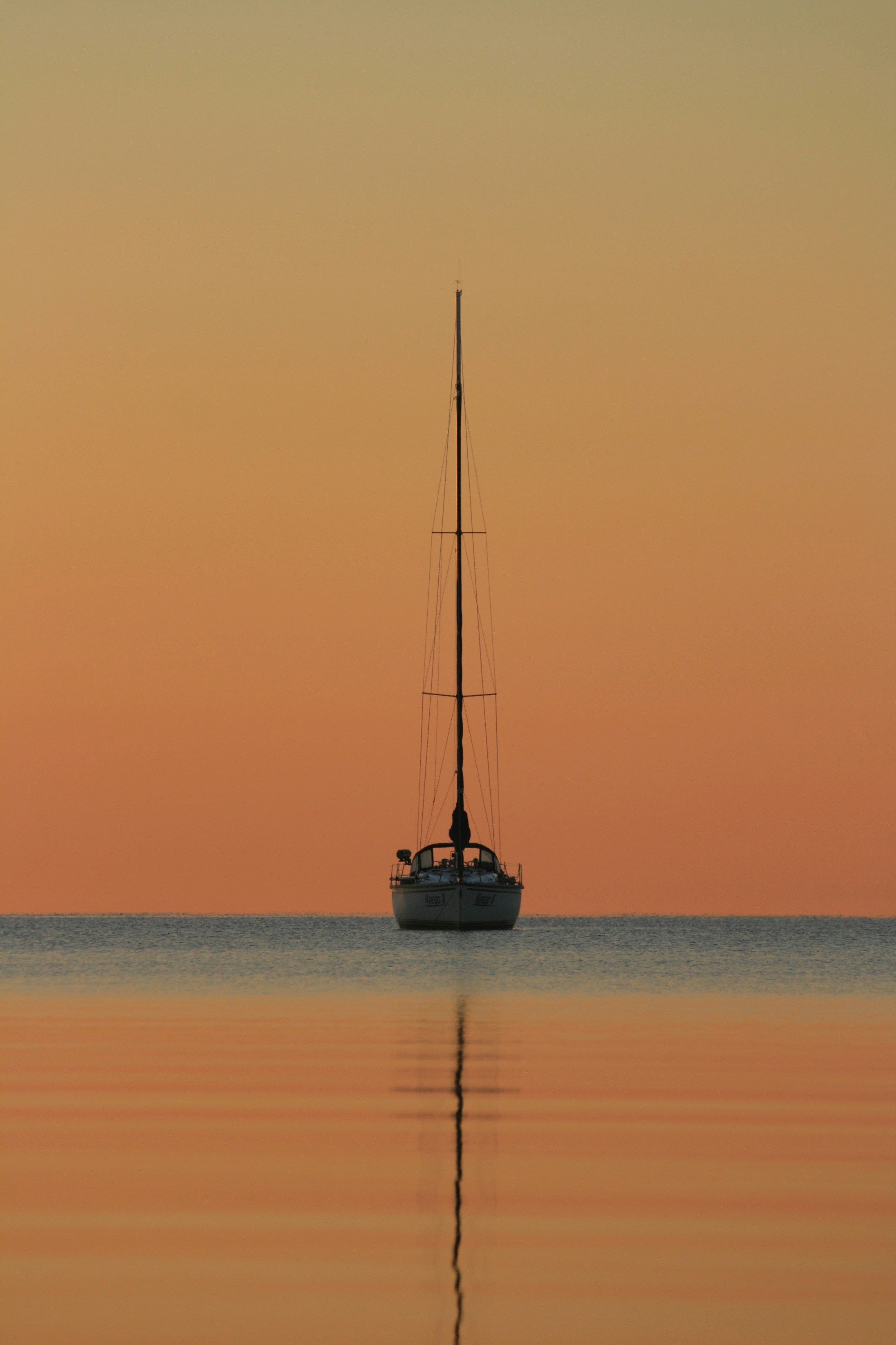 white and black boat on body of water during golden hour