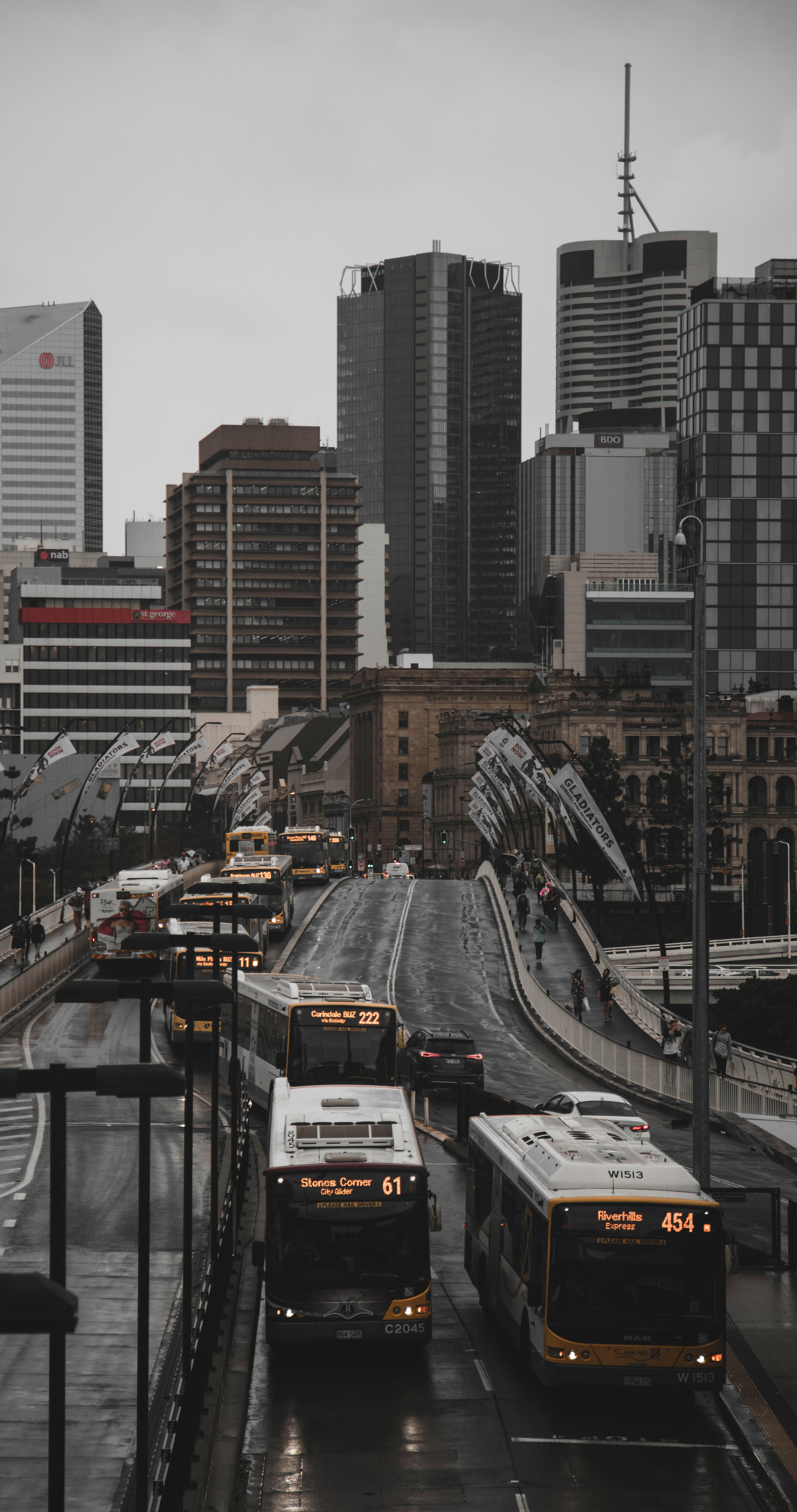 aerial photo of bus forming line while on road at daytime