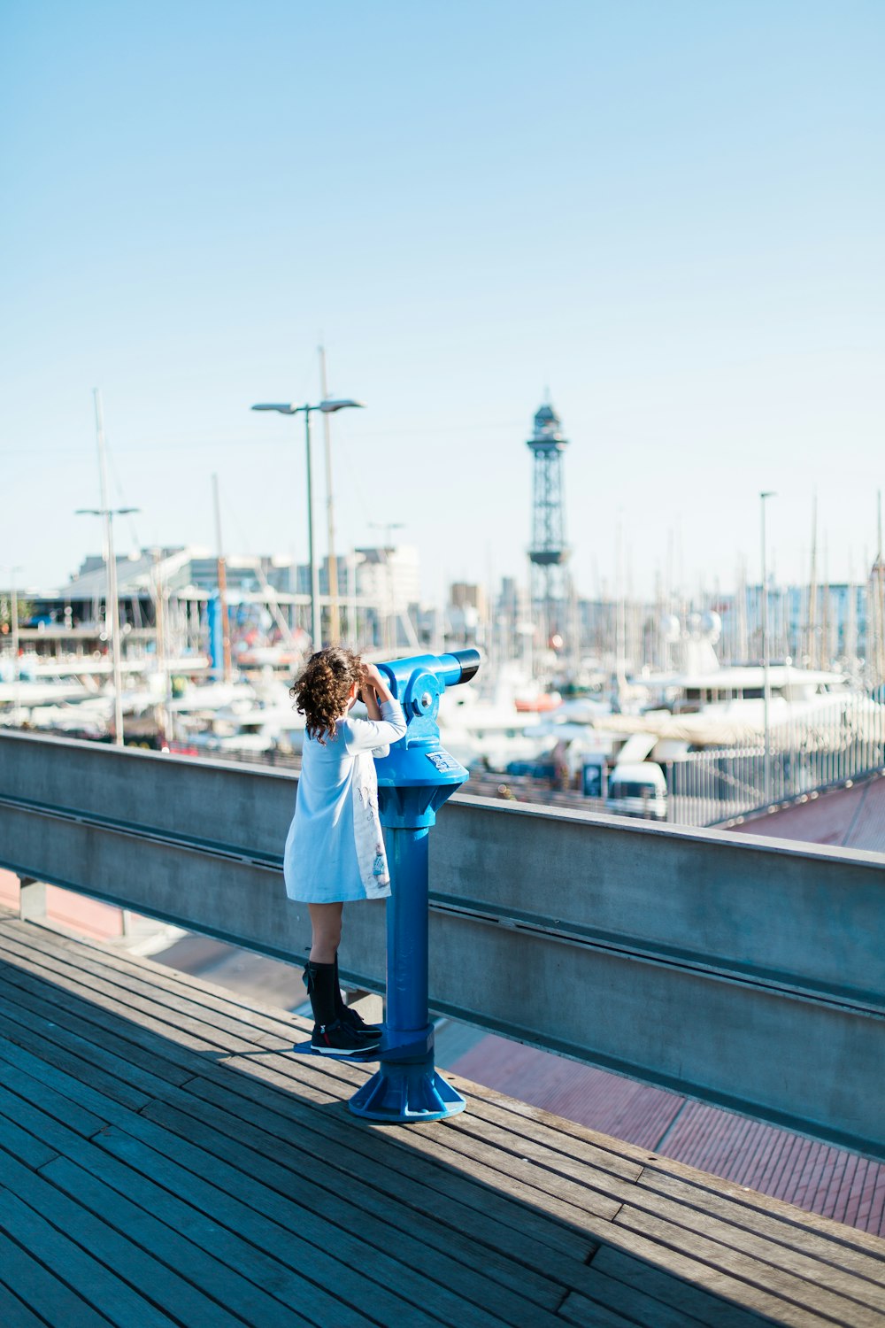 photography of girl using tower viewer