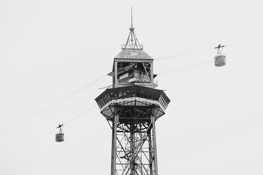 a black and white photo of a tower with a clock