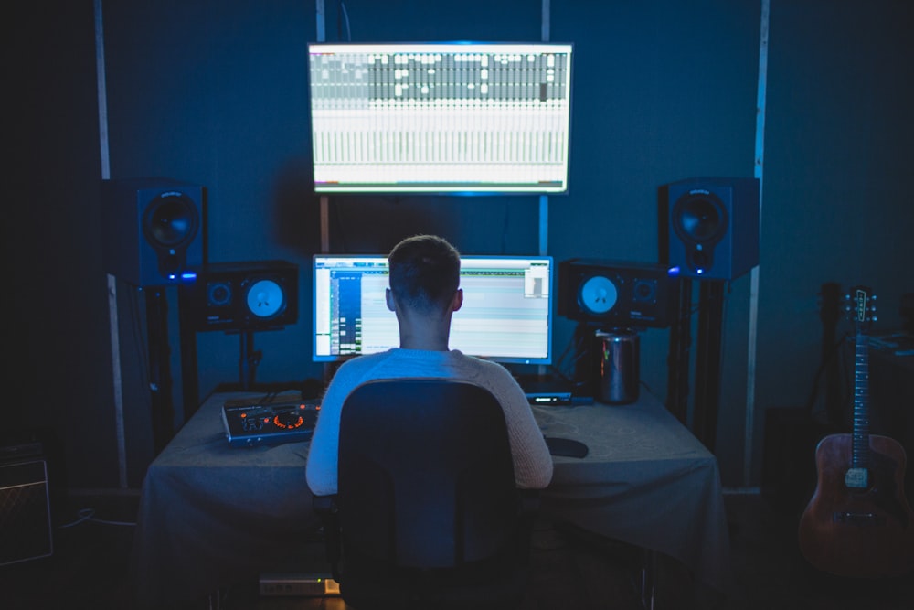 man sitting in front of computer