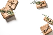 four brown gift boxes on white surface
