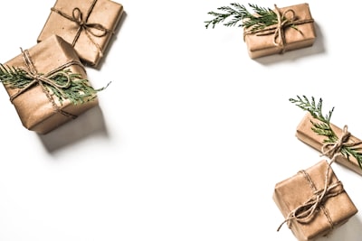four brown gift boxes on white surface presents zoom background