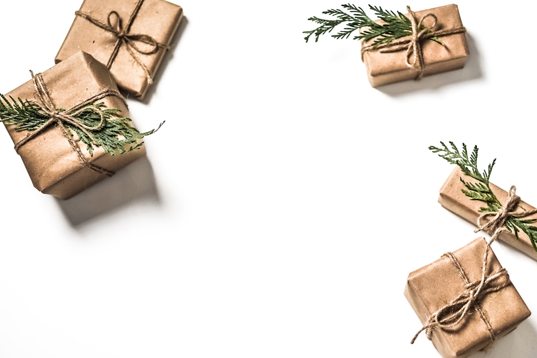 four brown gift boxes on white surface,