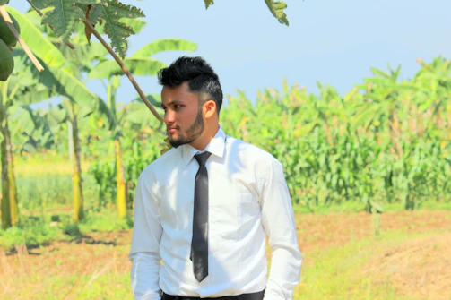 A warm handshake between two farmers in a lush banana plantation under a bright sky.