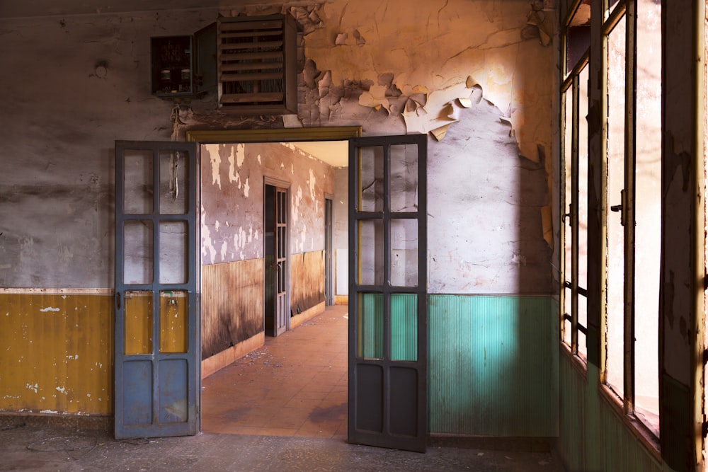 two gray wooden doors near brown painted wall