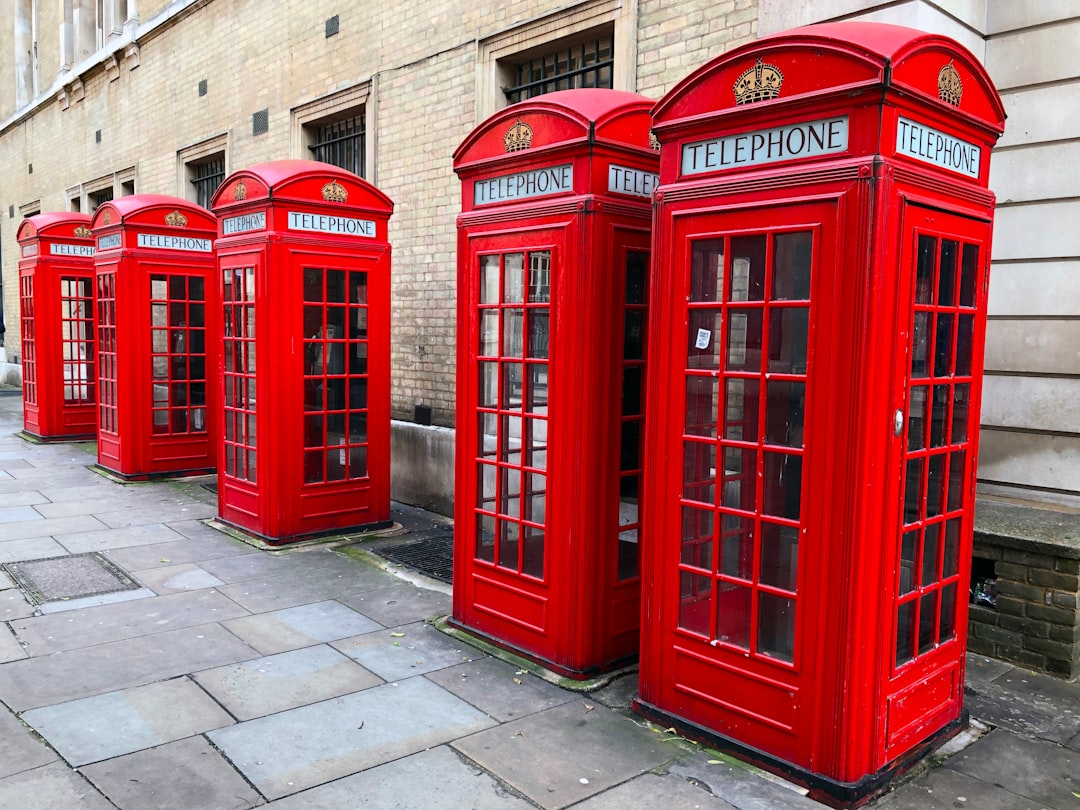 lined-up red telephone booths near building