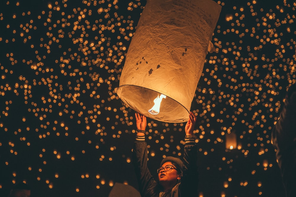 person holding paper lantern