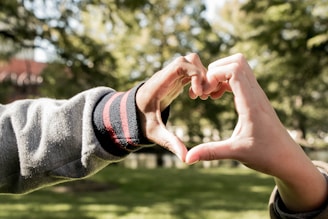 A heart symbol made of hands, representing unity and support.