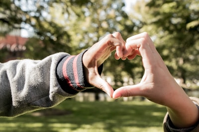 A heart symbol made of hands, representing unity and support.