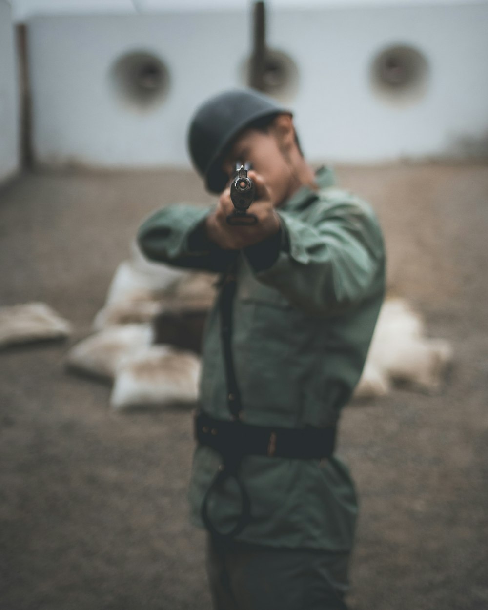 soldier pointing rifle during daytime