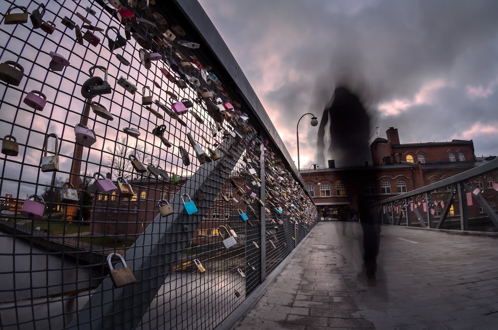 assorted padlock hanging on fence