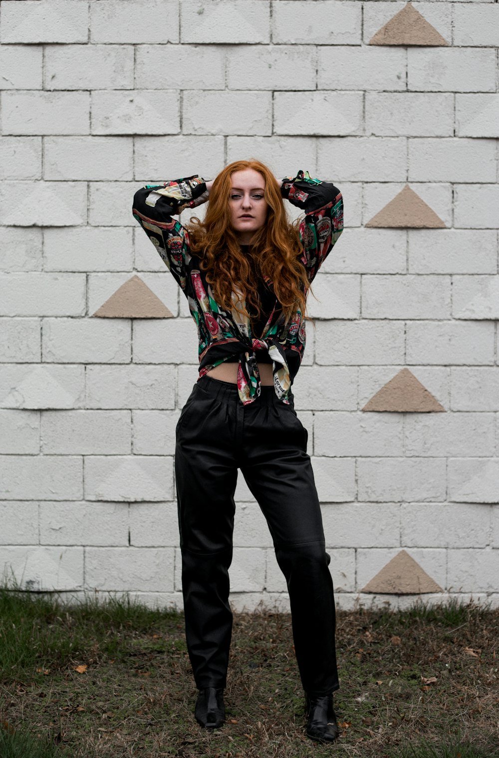 photo of woman wearing teal-and-black long-sleeved shirt and black pants