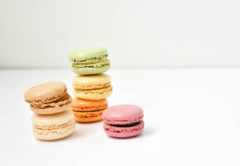 five macaroons on white surface
