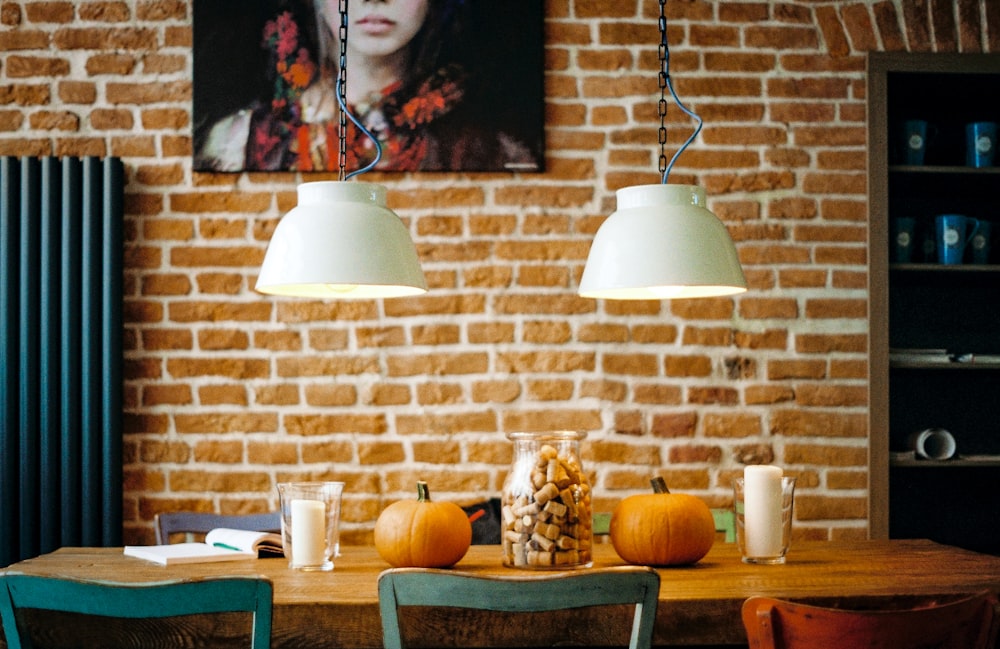 rectangular brown wooden table with two pumpkin on top