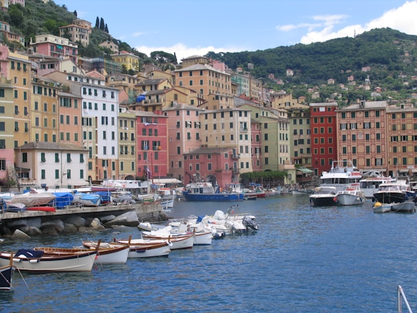 A scenic coastal village in Croatia with boats docked along the harbor and stone houses.