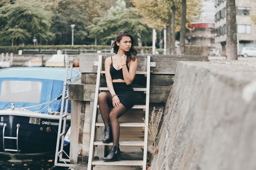 woman sitting on stairs looking somewhere