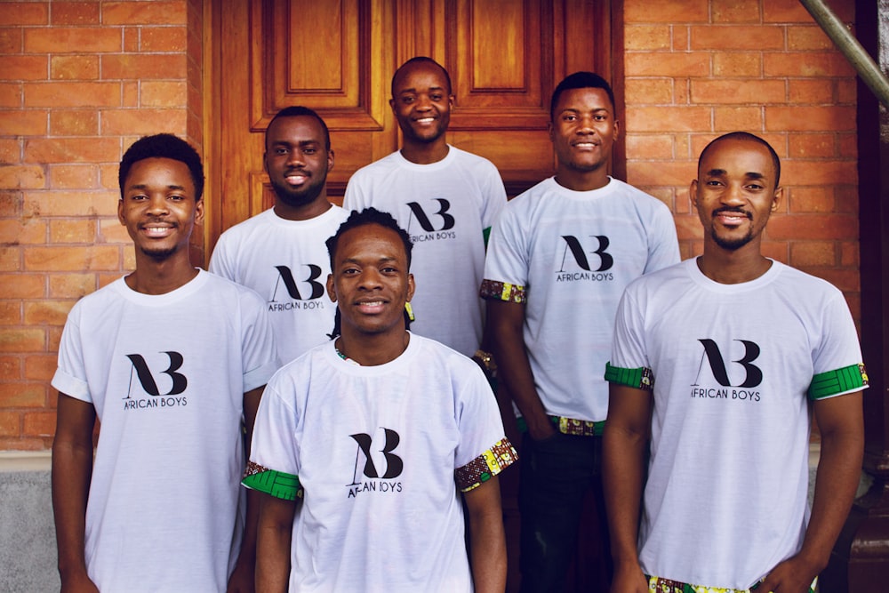 group of men standing near brown wooden door