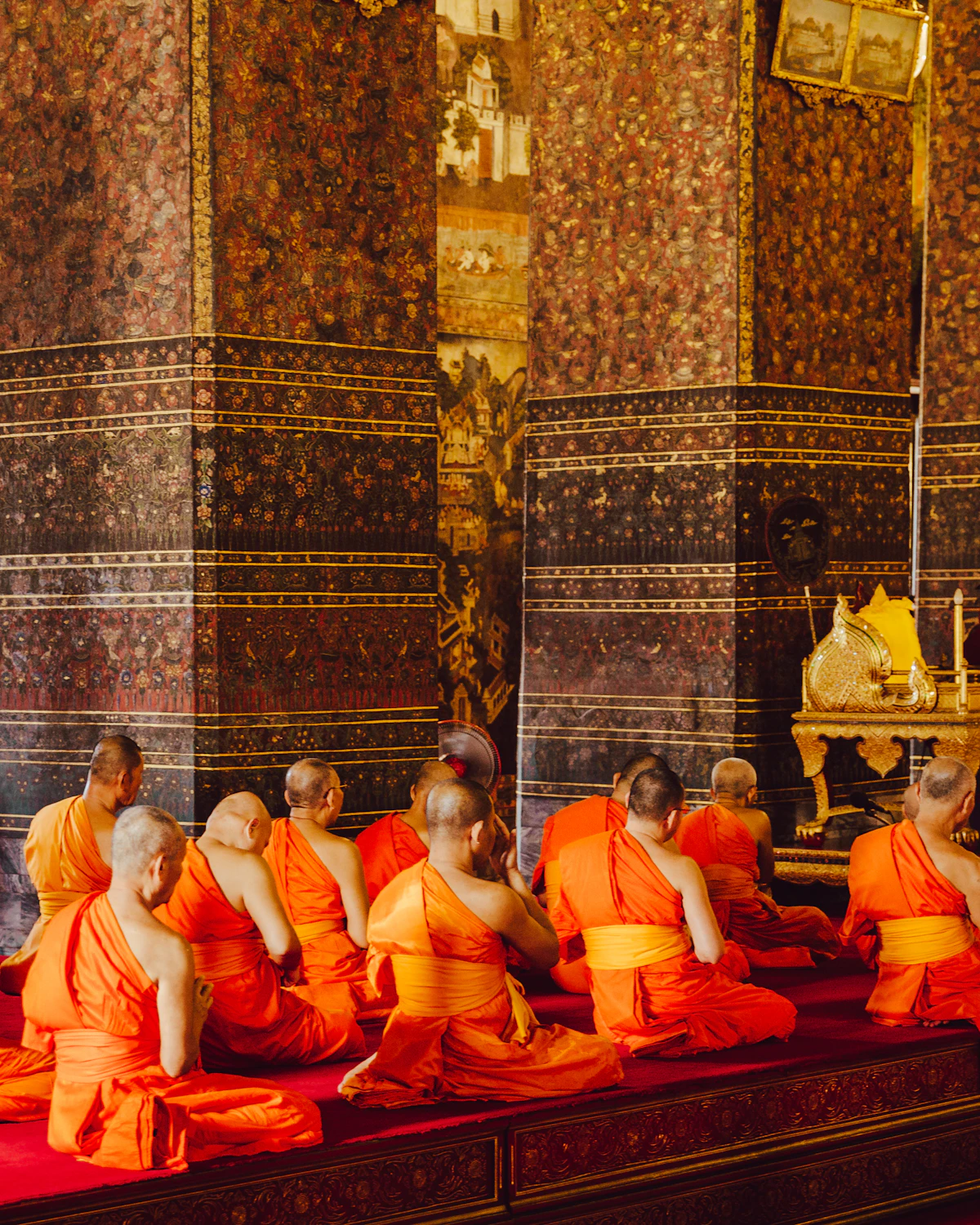 Thai monks seated together in a praying session
