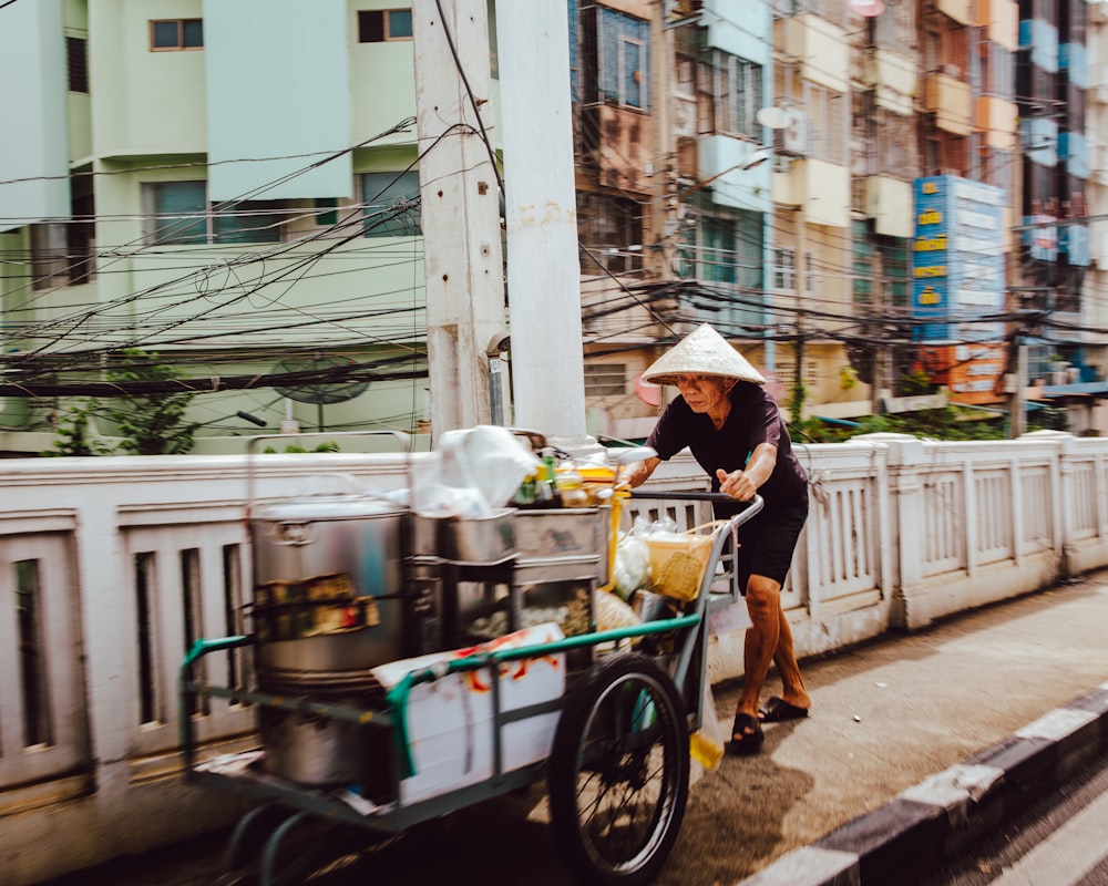 man pushing the cart on street