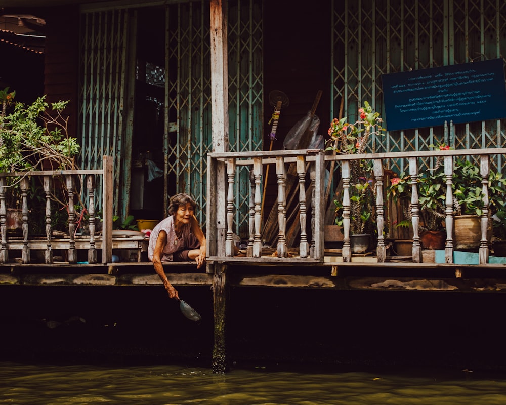 woman sitting on floor beside balusters