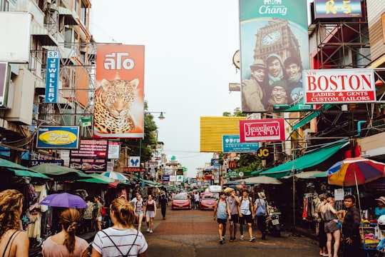 pathway with assorted product displays with people walking in Khao San Center Thailand