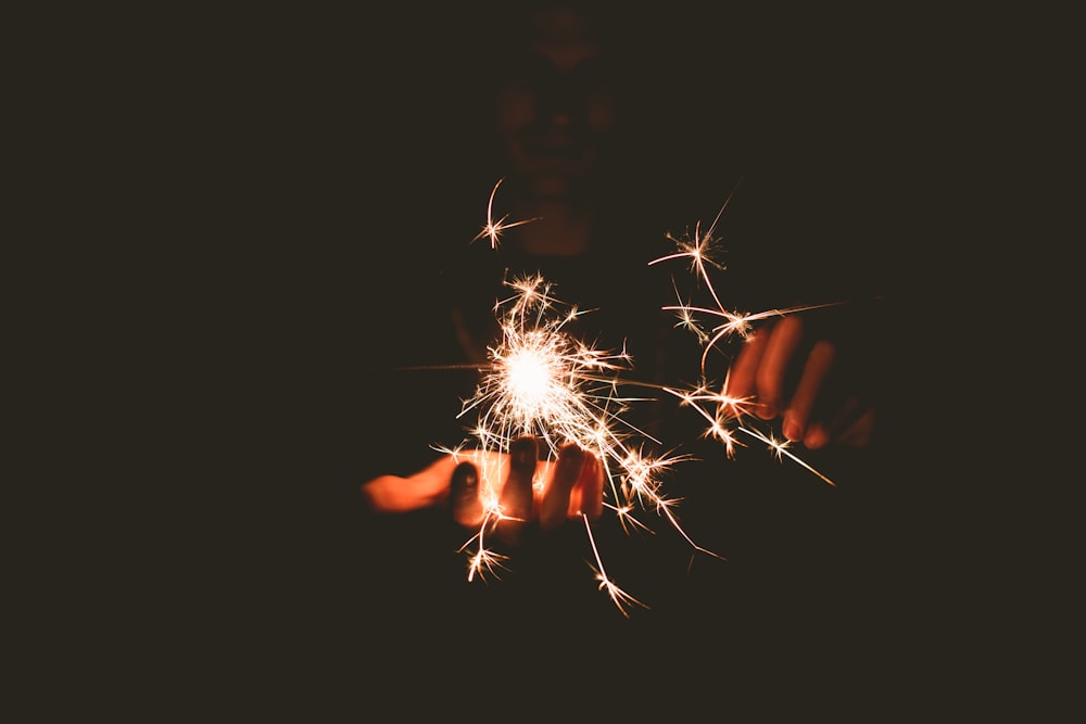 person holding sparkler