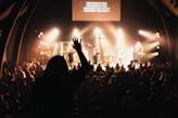 people inside building with band and spotlights