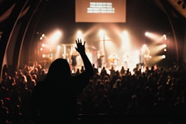 people inside building with band and spotlights