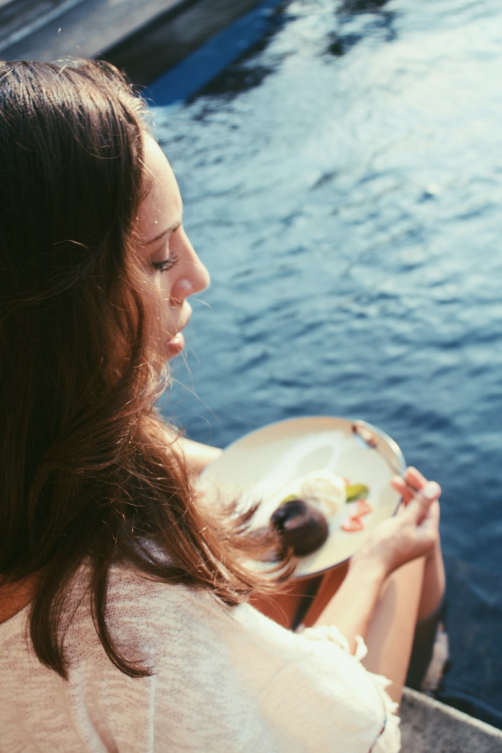 woman right foot on body of water